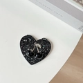 Macro detail of heart-shaped black glitter portable mirror with cherry decorative accent - Starry Silver Foil Cherry #2 / Black