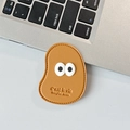 Detail of caramel leather phone socket with big eyes and C'est la vie embossed text - Leather Mango (Big Eyes) / Gold Brown