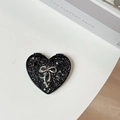 Close-up of heart-shaped black pocket mirror with silver glitter and metallic bow - Starry Silver Foil Bow #4 / Black