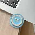 Détail du support de téléphone perle bleue avec nœud argenté sur un bureau en bois - Style Magnétique - Noeud en Perle Ronde / Bleu