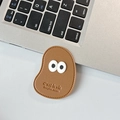 Detailed view of brown lychee leather phone stand with cute eyes and engraved text - Leather Mango (Big Eyes) / Coffee