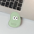 Close-up of mint green leather phone grip with big cartoon eyes and C'est la vie text - Leather Mango (Big Eyes) / Green