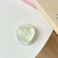 Detail of light green glitter heart phone socket with Gift For You print on white surface - Shimmering Light Green