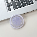 Macro detail of round purple glitter phone grip with iridescent sequins and white frame - Purple
