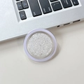 Detail of round phone grip showing white glitter sequins in a clear transparent case - White