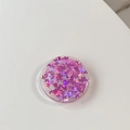 Detailed macro view of round phone grip featuring purple glitter butterfly sequins in resin - Gradient Butterfly - Laser Purple