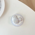Detail of Mickey-shaped rhinestones and plush fur trim on this luxury phone socket grip - Plush Rhinestone Mouse Head Shape / Iridescent