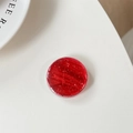Detalle de la textura de mármol rojo brillante y brillo en el soporte redondo para móvil - Rojo Cereza