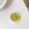 Detail of round olive green resin phone grip with elegant gold leaf glitter flakes - Yellow