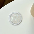 Macro view of shell-patterned MagSafe phone grip with iridescent pearly texture - Iridescent White