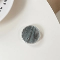 Macro view of round grip tok with grey marble pattern and silver glitter foil detailing - Gray