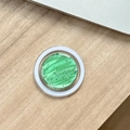 Detail der grünen MagSafe Handyhalterung mit Silberfolie auf einem Holztisch - Magnetische Epoxid-Silberfolie-Wasserwelle / Smaragdgrün