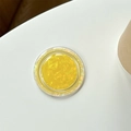 Detail of yellow round phone grip with crystal cut texture and pearl luster finish - Iridescent Yellow