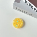 Close-up of a round phone socket stand with yellow heart sequins and holographic glitter - Candy Heart / Yellow
