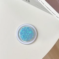 Macro view of blue heart sequins inside a clear magnetic MagSafe phone grip socket - Magnetic Drip Heart-Blue