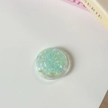 Détail macro d'un support de téléphone transparent rond avec paillettes bleu et vert - Support à Colle-Paillettes Macaron-N°6 Double Vert