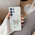 Detailed shot of Samsung Galaxy case with rhinestone butterfly and colorful glitter stars - Samsung A14 / Colorful Star Butterfly