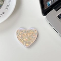 Vista macro dello specchio pieghevole a cuore con paillettes colorate su tavolo bianco - Paillettes Scintillanti Arancione (701562)