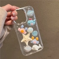 Funda iPhone 16 Pro Max con purpurina y colgantes 3D de ballena y cangrejo mar - Marco Galvanizado - Purpurina de Meteoro - Concha de Cangrejo / iPhone 16e