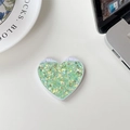 Close-up of heart-shaped folding mirror with green and champagne glitter on a desk - Glitter Sequin Green (701562)