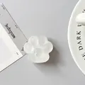 Detail of a cat paw phone grip with heart recess in translucent white silicone - Matte White
