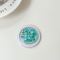 Detail shot of round phone grip with laser butterfly sequins in vibrant teal blue resin - Laser Lake Blue
