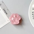 Macro shot of 3D pink cat paw phone grip with matte translucent resin finish - Matte Red