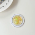Macro detail of a round phone grip featuring sparkling laser butterfly sequins in golden hues - Laser Yellow
