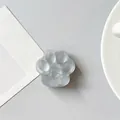 Detail of a translucent cat paw phone grip with heart relief on a minimalist desk - Matte Grey