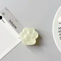 Close-up of translucent cat paw phone grip with a heart detail and smooth silicone texture - Matte Light Green
