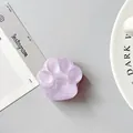Detail view of a 3D purple cat paw phone socket holder with a matte heart center design - Matte Purple