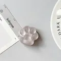 Detailed view of pink translucent cat paw phone grip with 3D heart-shaped pad detail - Matte Brown