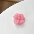 Detail of a matte pink flower phone grip with resin petals and beaded center - Magnetic Camellia / Rose Red