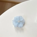 Detail of light blue floral phone socket with rhinestone center on white background - Magnetic Camellia / Blue