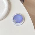 Detailansicht eines lila Kristallglas-MagSafe-Griffs für Smartphones auf weißem Tisch - Lila