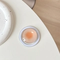 Detail view of crystal glass Magsafe phone grip with orange gradient and clear base - Orange Dots