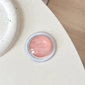 Macro shot of circular MagSafe phone stand with pink marble effect and clear glass dome - Textured Deep Pink