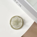 Macro shot of a matte green cat paw foldable phone socket with a heart-shaped detail - Jasmine Green