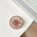 Detailed close-up of a semi-transparent cat paw MagSafe phone socket on a white surface - Brown