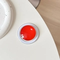 Top view of red crystal glass MagSafe phone grip with magnetic base on white surface - Red