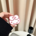 Pink cartoon frog collapsible phone grip holder accessory shown held by hand - Pink