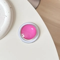 Detail view of pink crystal glass magnetic Magsafe phone grip on a white ceramic tray - Rose Red