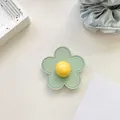 Detailed view of flower phone socket with green leather petals and yellow center bead - (Clear Stand) 3D Leather Flower - Green
