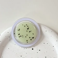 Macro shot of green translucent gel with leaf particles in a transparent jar on a plate - Magnetic Morandi Ink Splash Grass Green