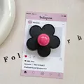 Detail of flower phone grip with black leather texture and pink glossy sphere center - (Magnetic) 3D Leather Flower - Black