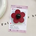 Close-up of wine red leather flower phone grip with stitching and black sphere center - (Magnetic) 3D Leather Flower - Wine Red