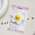 Detail of flower phone grip featuring white faux leather petals and yellow center - (Magnetic) 3D Leather Flower - Off-White/Yellow
