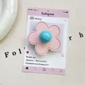 Detailed view of pink leather flower phone grip with blue bead center on white texture - (Magnetic) 3D Leather Flower - Light Pink