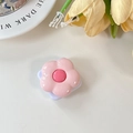 Detailed macro view of pink floral collapsible phone grip mirror with a purple base - Pink