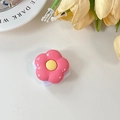 Detailed view of pink flower phone socket with a mirror finish on a clean white surface - Deep Rose